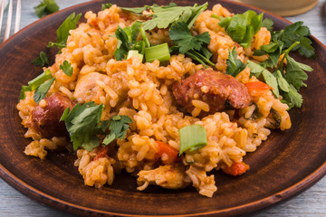 Classical Louisiana Jambalaya from chicken rice and smoked sausages - close-up