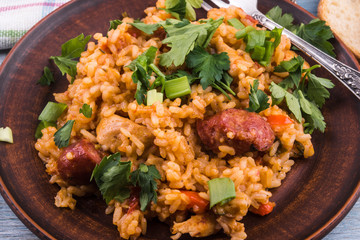 Classical Louisiana Jambalaya from chicken, rice and smoked sausages - close-up