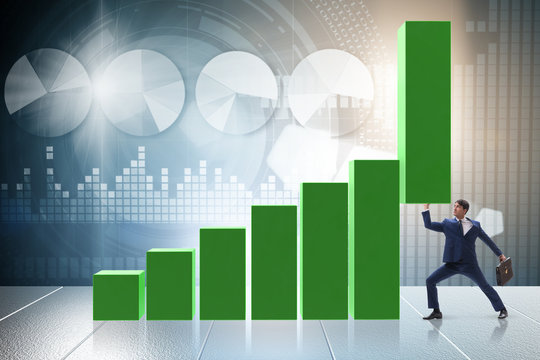 Businessman supporting growtn in economy on chart graph