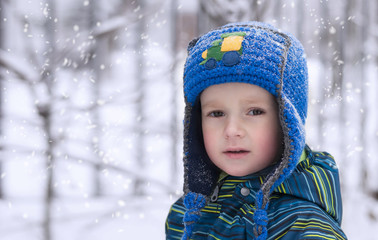close-up portrait of a cute little boy in winter clothes