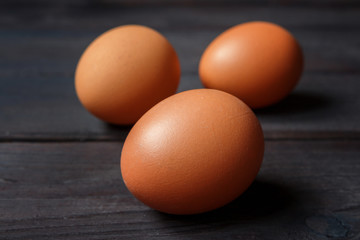 Eggs of brown chicken on a wooden background  with copy space in rustic vintage style