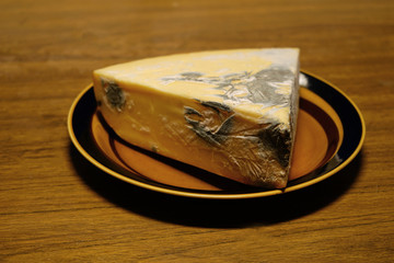Moldy cheese on the plate.