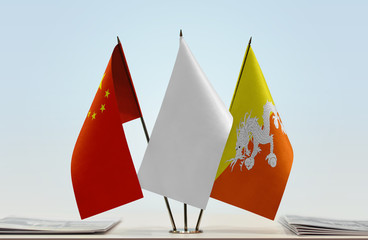 Flags of China and Bhutan with a white flag in the middle