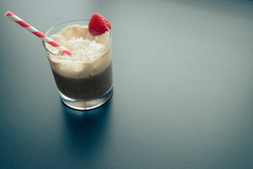 Morning espresso with whipped cream and strawberry