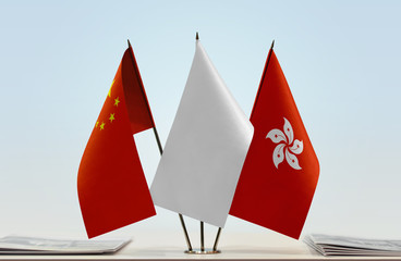 Flags of China and Hong Kong with a white flag in the middle