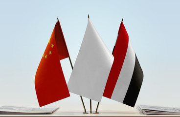 Flags of China and Yemen with a white flag in the middle