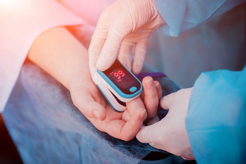 Pulse oximeter on the patient's hand