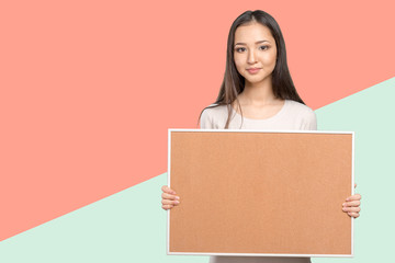 Young dark hair woman keeping cork board