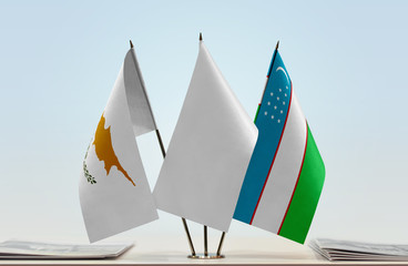Flags of Cyprus and Uzbekistan with a white flag in the middle