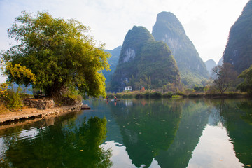 Fototapeta premium Beautiful landscape of karst mountains reflected in water, Yulong river in Yangshuo South China.