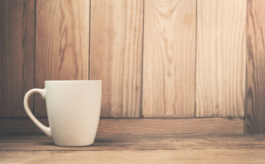 Fototapeta na wymiar Coffee cup on a wood background.