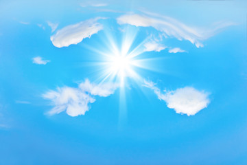 Beautiful blue sky with sunbeams and clouds. Sun rays