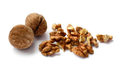 Two whole and many chopped nuts isolated on white background