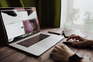 Man freelancer is working using laptop computer at home office. Freelance lifestyle workplace