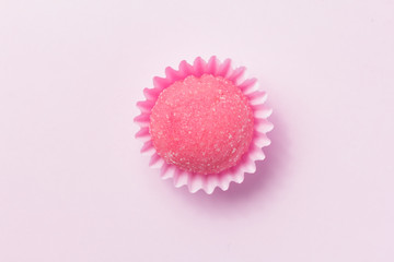 Bicho de pe is a strawberry flovoured brazilian candy. Children birthday party sweet. Top view of candy on pink background.