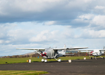 Fototapeta na wymiar Small single-engine airplane parjed on runway