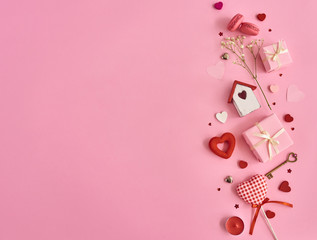 Valentines day background with a lot of different hearts, macaroons and gift box over pink background. Space for text