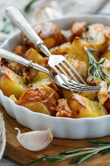 Potatoes baked with bacon, rosemary and garlic.