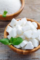 White refined sugar in a wooden bowl.