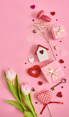 Valentines day background with a lot of different hearts,macaroons,pink tulips and gift box over pink background. Space for text