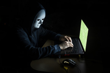 Young hacker  on a dark background