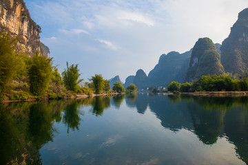 Fototapeta na wymiar Beautiful landscape of karst mountains reflected in water, Yulong river in Yangshuo South China.