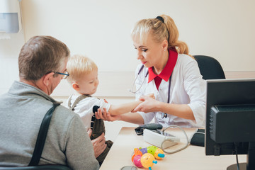 Doctor measuring blood pressure of a child.