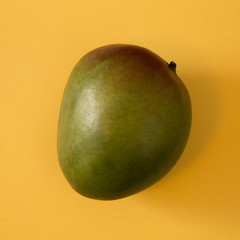 Mango Dramtically Lit on a Yellow Background