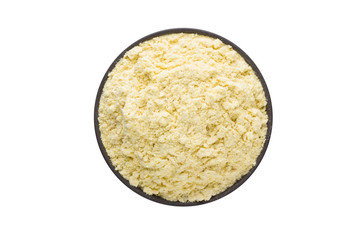 Fenugreek powder in clay bowl isolated on white background. Seasoning or spice top view