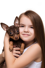 Portrait of a beautiful young girl caucasian snuggling with a cute terrier puppy dog, isolated on white background in studio