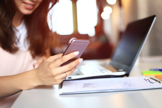 Woman worker relax with smartphone in work time.