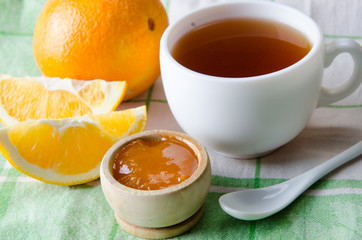 Cup of tea served with orange jam
