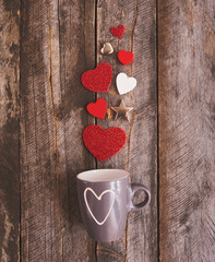 Valentines day background with valentines toy and cup over wood board