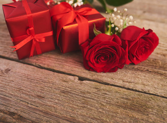 Valentines day background with red roses and gift box over wood board. Design mockup