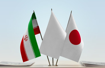 Flags of Iran and Japan with a white flag in the middle