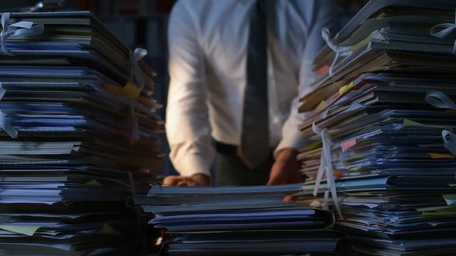 Office clerk stacking paperwork
