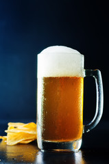 Beer in glass with chips