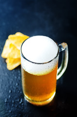 Beer in glass with chips
