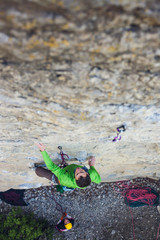 A man is a rock climber on a rock.