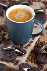 Chocolate biscuit cookies with coffee mug on wooden table