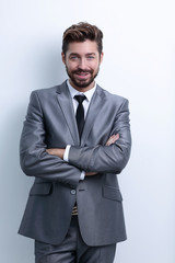 Portrait of a happy business man on a gray background