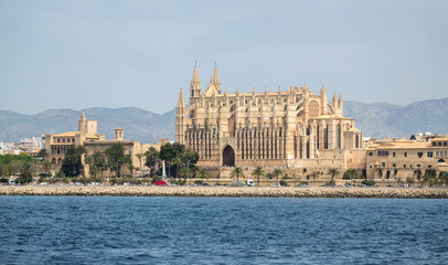 Fototapeta premium Cathedral Basilica Santa Maria of Palma de Mallorca views from the bay. La Seu Spain. Built on the Roman and Renaissance walls that protected the city from the coast