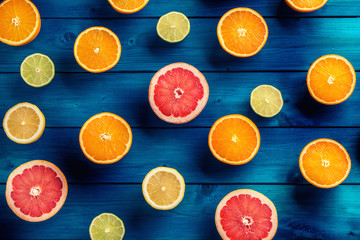 Oranges limet lemon and grapefruit on blue table.