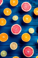 Oranges limet lemon and grapefruit on blue table.