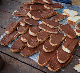 Toasts with peanut butter on a clay plate