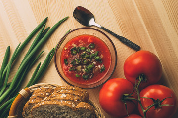 Tomato sauce in glass bowl, fresh bread, onion on wooden table, sauce ingredients for homemade  vegetarian healthy food