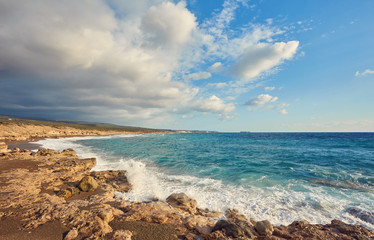 Fototapeta na wymiar Beautiful wild beach with clear turquoise water and waves.