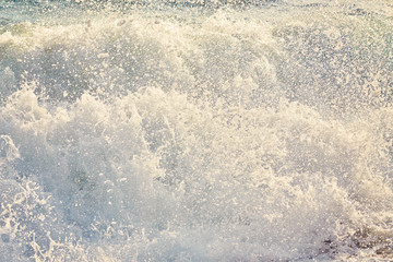 Beautiful wild beach with clear turquoise water and waves.