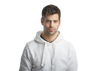 Obraz premium Casual young man portrait. Portrait of young man wearing hoodie while standing at isolated white background with copy space. 