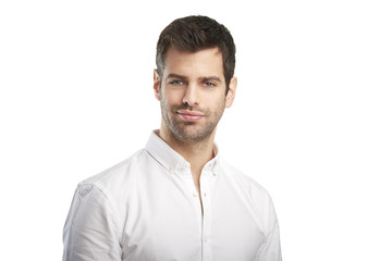 Confident young professional man portrait. Smiling young businessman standing at isolated white background and looking at camera. 